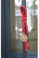Medalla rústica de  San Fermín en latón. Hecha artesanalmente por Sandra Bellew.