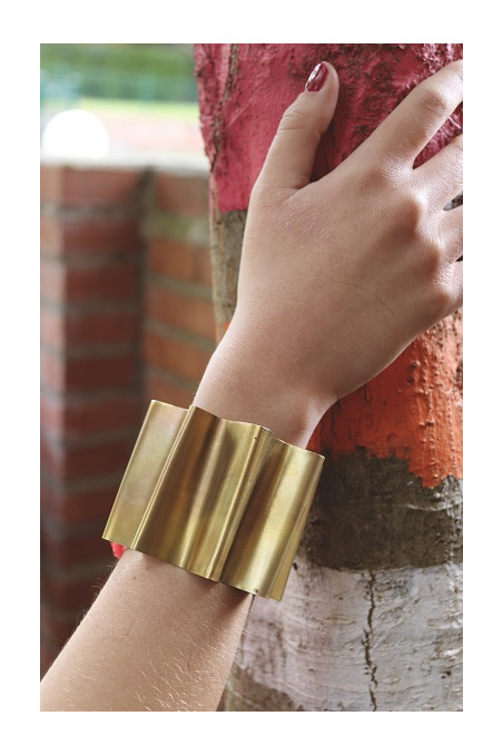 Brazalete en forma de abanico en latón con cinta de seda. Hecho artesanalmente por Sandra Bellew.