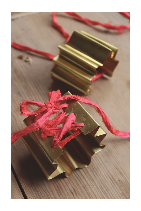 Brazalete en forma de abanico en latón con cinta de seda. Hecho artesanalmente por Sandra Bellew.