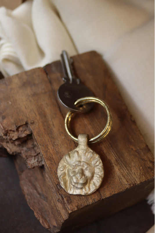 Llavero rústico con imagen de flor de león en latón. Hecho artesanalmente en España por Sandra Bellew.