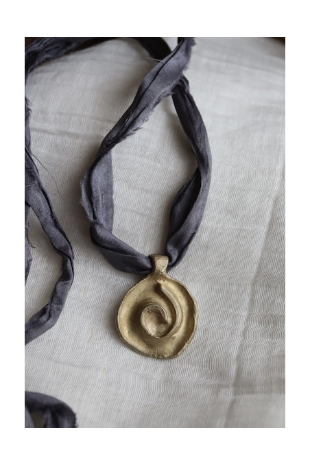 Colgante rústico de espiral celta en latón. Hecho artesanalmente en España por Sandra Bellew.