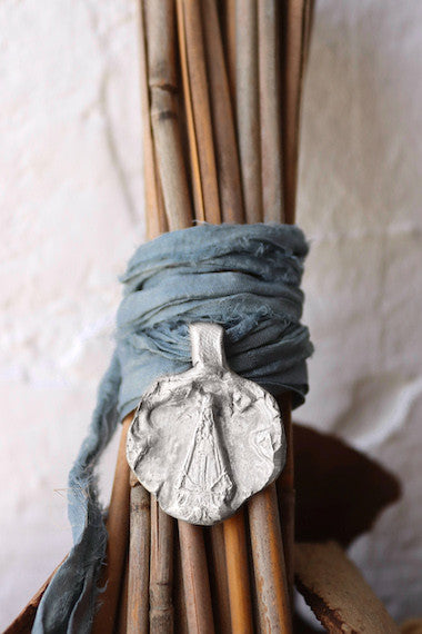 Medalla rústica de la Virgen de Begoña para ramo de novia en plata. Hecha artesanalmente en España por Sandra Bellew.