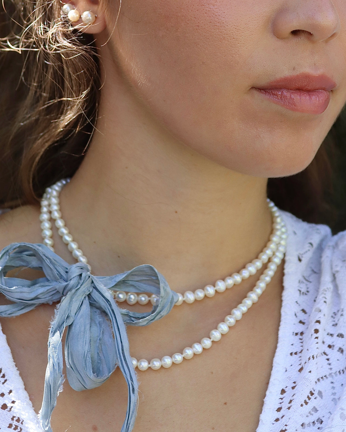 Collar de perlas blancas con cinta de seda